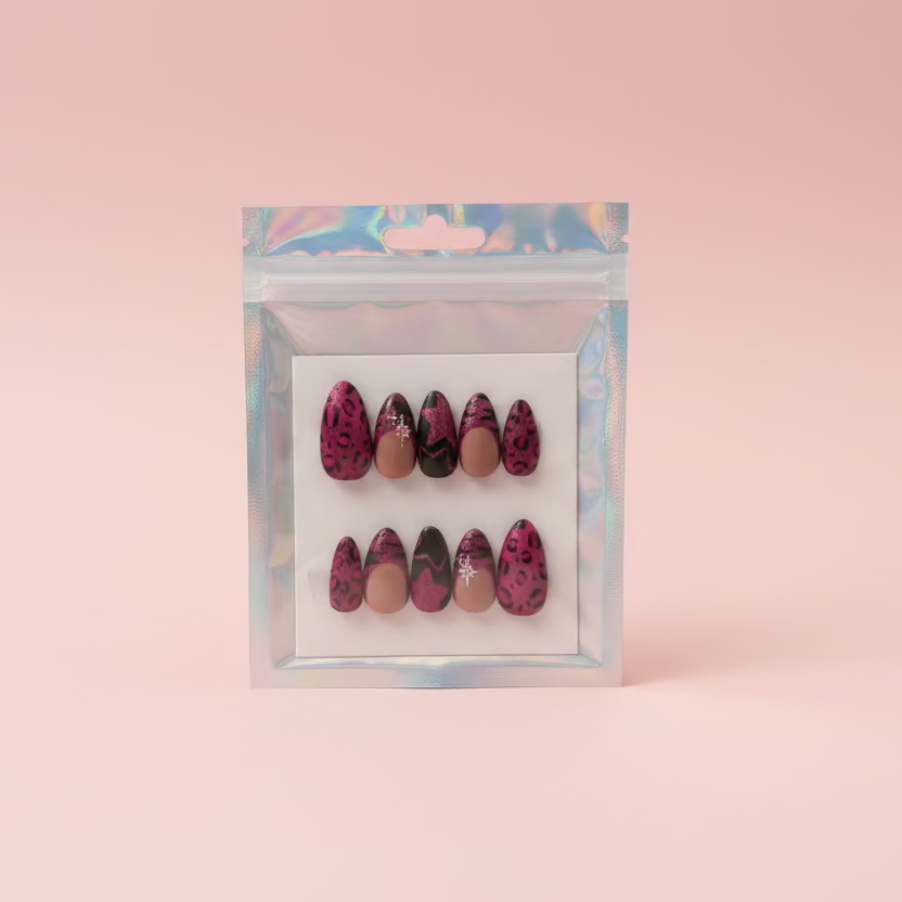 Set of decorative nails in a clear plastic bag on a cardboard surface.